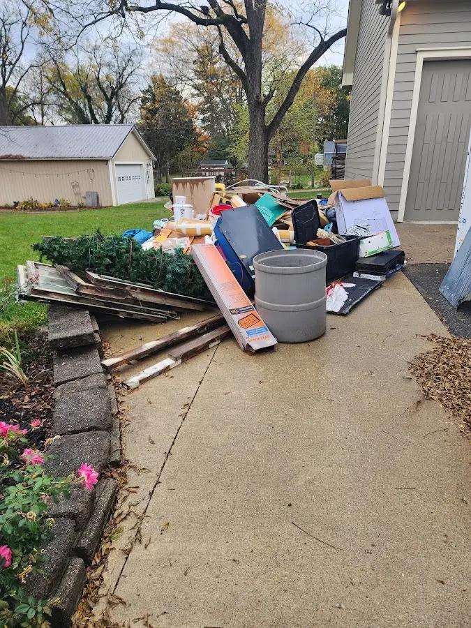 Dumpster being loaded with debris for Estate Cleanout Dumpster Rental in Slaton